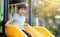 Young asian boy playing on a yellow playground slide