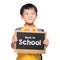 Young asian boy smile holding BACK TO SHCOOL chalkboard over white