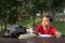 Young asian boy studying at park while looking at empty space