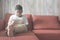 Young asian boy using digital tablet on a sofa at home focus on feet.
