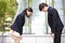 Young Asian business executives bowing to each other