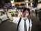 Young Asian business man taking a picture or selfie in the street at night. Social and internet of thing concept