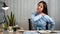 Young Asian Business woman sitting on the chair stretching herself and exercise for relaxation while working hard at office