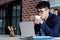 Young asian businessman drinking coffee and working with laptop computer at office, business office lifestyle concept