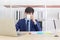 A young Asian businessman sits an afternoon coffee on the desk