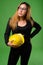 Young Asian businesswoman with hardhat against green background