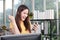 Young Asian businesswoman holding a smartphone smiling happy at work.