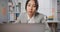 Young Asian businesswoman sit on desk with laptop overworked tired burnout syndrome at office. Exhausted lady with sleeply eye at