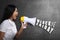 Young asian businesswoman using megaphone to announce about Black Friday