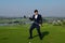 Young Asian CEO Businessman wearing suite playing golf at the golf course. Portrait of Asian businessman joying to success