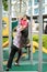 Young asian children hang on the monkey bar. To exercise at outdoor playground in the neighbourhood