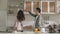 young asian couple dancing in kitchen at home