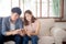 Young asian couple or friend looking smart mobile phone with enjoy at living room