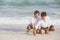 Young asian couple gay smiling romantic drawing heart shape together on sand in vacation