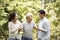 Young asian couple helping old man walk