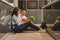 Young asian couple husband and wife sitting on floor in kitchen having romantic and fun moment during coronavirus pandemic lock