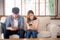 Young asian couple sitting on sofa with problem about relationship because addicts social network media together