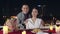 Young asian couple take photo for memory of happiness moment at romantic dinner in rooftop restaurant at city night with sweet