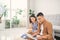 Young Asian couple watching a video on laptop in the living room