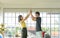 Young asian couple wear casual clothing giving high five to each other and smiling in living room