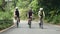 young asian cyclists riding bicycles on rural road