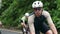 young asian cyclists riding bicycles on rural road