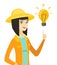 Young asian farmer pointing at idea light bulb.