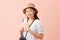 Young asian female isolated on pink background holding airplane tickets that she bought on sale