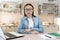 A young Asian female specialist psychologist conducts online patient appointments, from a laptop