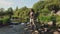 A young asian female standing fly fishing in a riffle on a river