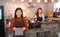 Young Asian female waitress wear apron and showing menu to customer business owner food and drink cafe concept.