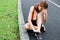 Young Asian fitness woman runner suffering from broken twisted ankle. Running injury accident concept.