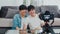 Young Asian gay couple influencer couple vlog at home. Teen korean LGBTQ+ men happy relax fun using camera record vlog video