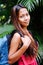 Young Asian girl with the back pack traveling through tropical forest