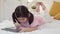 Young Asian girl drawing at home. Asia japanese woman child kid relax rest fun happy using tablet draw cartoon before sleep lying
