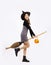 Young asian girl in halloween costume wearing black witch hat holding pumpkin lantern and witch broom posing on white background