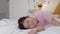 Young Asian girl play after wake up at home. Asia japanese woman child kid relax rest fun after sleep all night lying on bed, feel