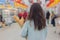 Young Asian girl shopping in a supermarket. Woman buys fruit and dairy product.