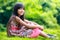 Young asian girl sitting on the green