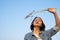 Young asian girl wear Jetket Jean hold grass flower .Blue sky background