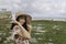 A young Asian girl wearing a beach hat is relaxing on the blue sky beach at Gunungkidul, Indonesia