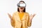 Young asian girl wearing VR glasses, looking amazed, using virtual reality headset, posing against white background