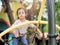 Young Asian girls are having fun clambering on rope nets in a playground