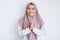 Young Asian Islam woman wearing headscarf gives greeting hands at with a big smile on her face. Indonesian woman on gray