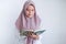 Young Asian Islam woman wearing headscarf is praying or read Quran - the holy book of Islam with smile and serious face.