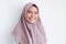 Young Asian Islam woman wearing headscarf with smile in face to camera. Indonesian woman. Beauty concept isolated on gray