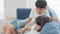 Young Asian kids, brother and sister watching video clip on digital tablet at home