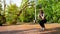 Young asian lady exercise in public park in daytime with beautiful smile in face, sunny green and sunny in topical country