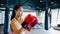 Young Asian lady kickboxing exercise workout punch doing shadow female fighter practice boxing in gym fitness class. Sportswoman