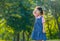 Young Asian little girl play alone in the garden with morning light